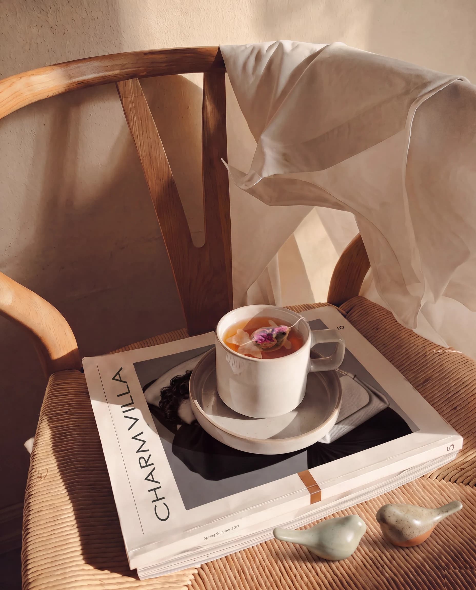 Goldfish tea and Songbird Chopstick Rests on a chair in afternoon sun