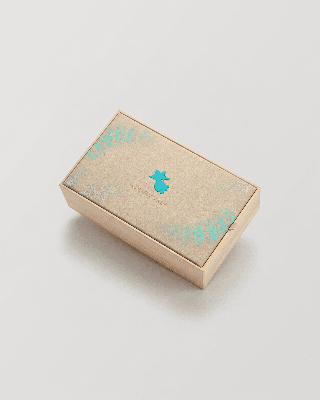 Joyful Reunion champagne-gold embroidered gift box, angled view